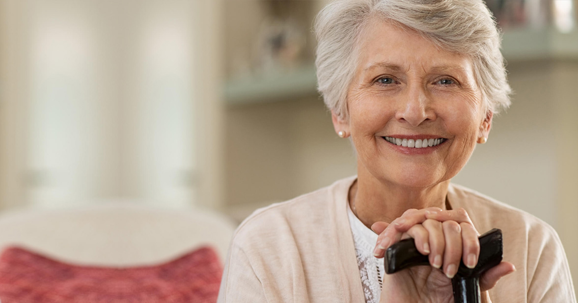 Aging specific senior care woman with cane