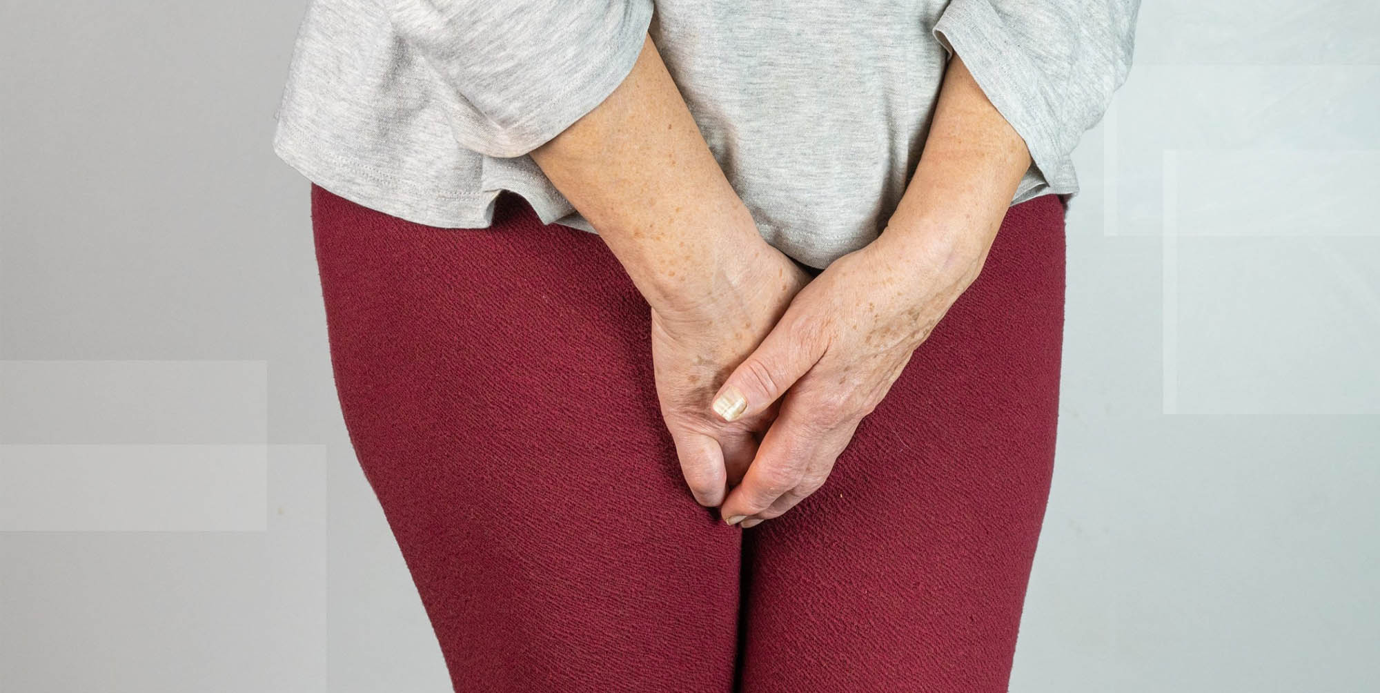 Incontinent woman holding herself continence management