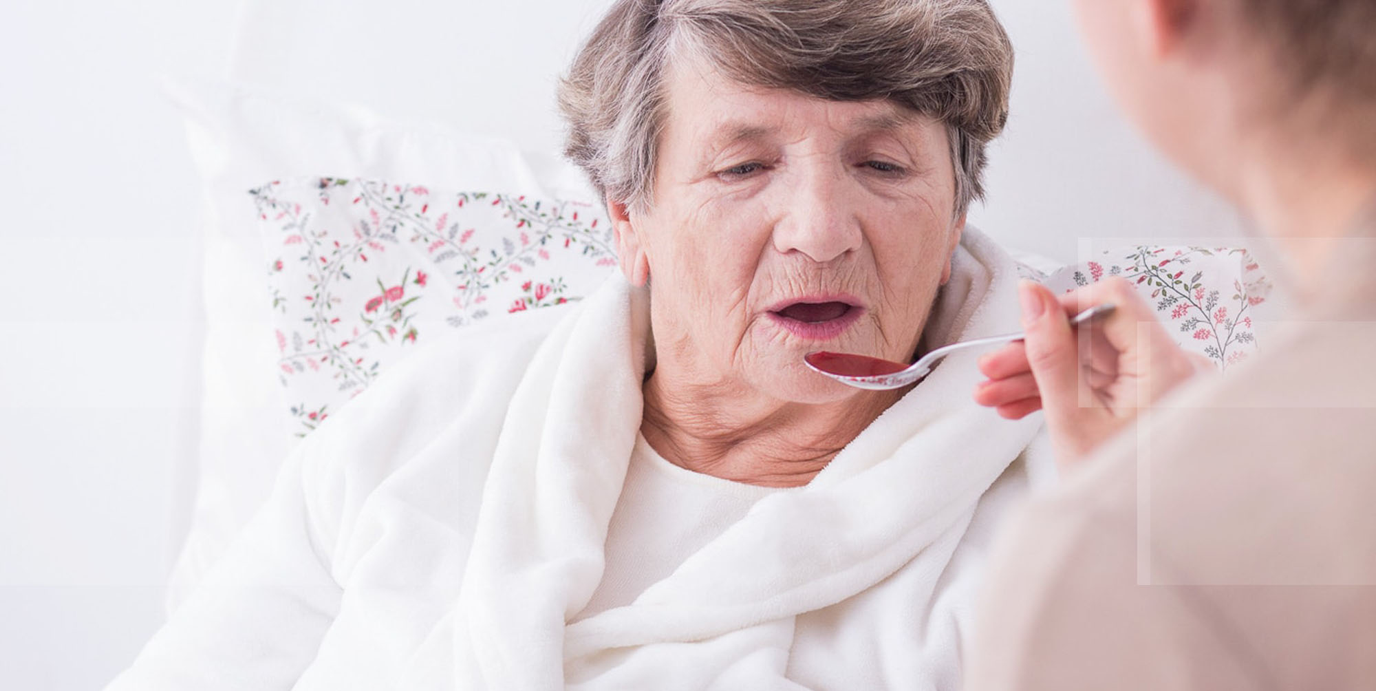 Feeding Assistsance helping elderly woman eat soup